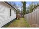 View of fenced backyard with grass with small staircase to another property level at 98 Ring Sw Ave, Concord, NC 28025