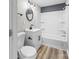 This bathroom includes vanity with black hardware, mirror, toilet, and a combined bathtub and shower at 98 Ring Sw Ave, Concord, NC 28025