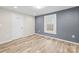 This bedroom features light-colored walls, a door with a bathroom sign, and light-colored flooring at 98 Ring Sw Ave, Concord, NC 28025