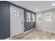 Light-filled entryway showcasing the beautiful flooring, a door, and multiple windows at 98 Ring Sw Ave, Concord, NC 28025