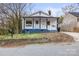 Beautifully renovated home with a charming front porch, and a newly landscaped front yard at 98 Ring Sw Ave, Concord, NC 28025