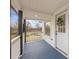 Close up of the covered porch with a white front door with glass, trimmed with a wreath at 98 Ring Sw Ave, Concord, NC 28025