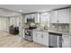 Updated kitchen features stainless steel appliances, granite countertops, and decorative backsplash at 98 Ring Sw Ave, Concord, NC 28025