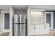 Convenient kitchenette featuring granite counters, white cabinets and stainless steel refrigerator at 98 Ring Sw Ave, Concord, NC 28025