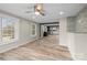 Spacious living room showcasing wood-look floors, bright windows, and an open layout to the kitchen at 98 Ring Sw Ave, Concord, NC 28025
