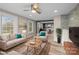 Open-concept living room with lots of natural light flows into the updated kitchen and dining area at 98 Ring Sw Ave, Concord, NC 28025