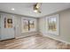 Well-lit room featuring multiple windows, new wood-look flooring, and neutral color scheme at 98 Ring Sw Ave, Concord, NC 28025