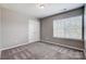 Neutral bedroom with window and closet featuring plush carpet and natural light at 10153 Elizabeth Crest Ln, Charlotte, NC 28277