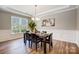 Elegant dining room featuring decorative molding, dark wood floors and a modern chandelier at 10153 Elizabeth Crest Ln, Charlotte, NC 28277