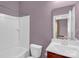 Standard bathroom featuring a shower-tub combo, toilet, and vanity sink with a framed mirror at 10605 Three Rivers Ct, Charlotte, NC 28273