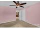 Bedroom with ceiling fan and view through doorway to sitting room at 10605 Three Rivers Ct, Charlotte, NC 28273