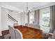 Formal dining area featuring a modern chandelier, long wood table, and large windows at 10605 Three Rivers Ct, Charlotte, NC 28273