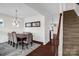 Formal dining room with elegant chandelier, wainscoting, and hardwood floors at 10605 Three Rivers Ct, Charlotte, NC 28273