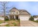 Inviting two-story home with a two car garage, well-maintained lawn, and a welcoming porch at 10605 Three Rivers Ct, Charlotte, NC 28273