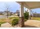 Pillared porch with stone accents overlooking a well-manicured lawn with other homes in the distance at 10605 Three Rivers Ct, Charlotte, NC 28273