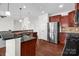 This is a great kitchen featuring a stainless steel refrigerator, an island, and brown cabinets at 10605 Three Rivers Ct, Charlotte, NC 28273