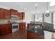 A gorgeous kitchen includes stainless steel appliances and stone countertops at 10605 Three Rivers Ct, Charlotte, NC 28273
