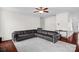 Open living room with a modern ceiling fan, gray leather sectional, and neutral walls at 10605 Three Rivers Ct, Charlotte, NC 28273