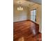 Elegant dining room with hardwood floors, crown molding, and a stylish chandelier at 10607 Old Bridge Ln, Charlotte, NC 28269
