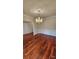 Elegant dining area with hardwood floors, wainscoting, and classic chandelier at 10607 Old Bridge Ln, Charlotte, NC 28269