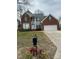 Charming two-story brick home with a well-manicured lawn and a two-car garage at 10607 Old Bridge Ln, Charlotte, NC 28269