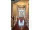 Inviting hallway featuring wood floors, views to main living spaces, and generous ceiling height at 10607 Old Bridge Ln, Charlotte, NC 28269