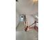 Upstairs hallway with carpet flooring, white walls, and stairs with wooden railings at 10607 Old Bridge Ln, Charlotte, NC 28269