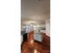 Open kitchen with white cabinetry, center island, and hardwood flooring at 10607 Old Bridge Ln, Charlotte, NC 28269