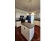 A kitchen featuring white cabinets, black appliances, an island and mosaic tile backsplash at 10607 Old Bridge Ln, Charlotte, NC 28269