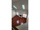 Spacious living room with hardwood floors, fireplace, and skylights providing natural light at 10607 Old Bridge Ln, Charlotte, NC 28269