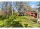Backyard area with grass and a wooden deck perfect for relaxing outdoors at 10820 Hunters Trace Ct, Charlotte, NC 28262