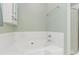 Soaking tub ready for use with a shower and storage in the light green bathroom at 10820 Hunters Trace Ct, Charlotte, NC 28262