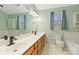 Bathroom boasts a double sink vanity, mirrors, and cabinets for storage at 10820 Hunters Trace Ct, Charlotte, NC 28262