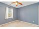 Simple bedroom featuring a window and ceiling fan at 10820 Hunters Trace Ct, Charlotte, NC 28262