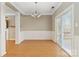 Dining room featuring paneled walls, chandelier lighting, and sliding glass doors at 10820 Hunters Trace Ct, Charlotte, NC 28262