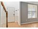 Bright entryway with wood floors, a staircase, and a window with natural light at 10820 Hunters Trace Ct, Charlotte, NC 28262