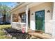 Welcoming front porch features classic columns, space for seating, and a secure CPI security system at 10820 Hunters Trace Ct, Charlotte, NC 28262