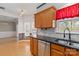 Charming kitchen features granite countertops, stainless steel appliances, and wood cabinets at 10820 Hunters Trace Ct, Charlotte, NC 28262
