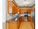 Well-equipped kitchen featuring stainless steel appliances, granite countertops, and wood cabinets at 10820 Hunters Trace Ct, Charlotte, NC 28262