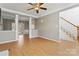 Spacious living room showing stairs, neutral walls, and hardwood floors at 10820 Hunters Trace Ct, Charlotte, NC 28262