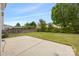 Beautiful backyard with a concrete patio, lush lawn, mature trees, and a privacy fence at 10933 Sedgemoor E Ln, Charlotte, NC 28277