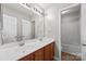 Bright bathroom featuring double sinks, wood cabinets, and a tub and shower combo at 10933 Sedgemoor E Ln, Charlotte, NC 28277