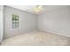Bedroom featuring neutral carpet and a window at 10933 Sedgemoor E Ln, Charlotte, NC 28277