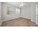 Bedroom with lots of natural light from two windows and light wood flooring at 10933 Sedgemoor E Ln, Charlotte, NC 28277