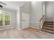 Open-concept entryway with hardwood flooring, a staircase with carpeted treads, and high ceilings for a grand entrance at 10933 Sedgemoor E Ln, Charlotte, NC 28277