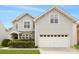 A beautiful two-story home showcasing a well-manicured lawn and a spacious two-car garage at 10933 Sedgemoor E Ln, Charlotte, NC 28277