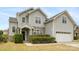 Charming two-story home with a stone accent wall, well-maintained landscaping, and a two-car garage at 10933 Sedgemoor E Ln, Charlotte, NC 28277