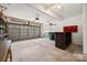 Large garage with overhead door, storage cabinets, and plenty of space for multiple vehicles at 10933 Sedgemoor E Ln, Charlotte, NC 28277