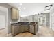 Open concept kitchen with stainless steel appliances and eat-in counter leading to living room at 10933 Sedgemoor E Ln, Charlotte, NC 28277