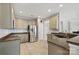 Kitchen with stainless steel refrigerator, eat-in counter, and gray cabinets at 10933 Sedgemoor E Ln, Charlotte, NC 28277